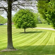 Grass Whisperers Lawn Care logo
